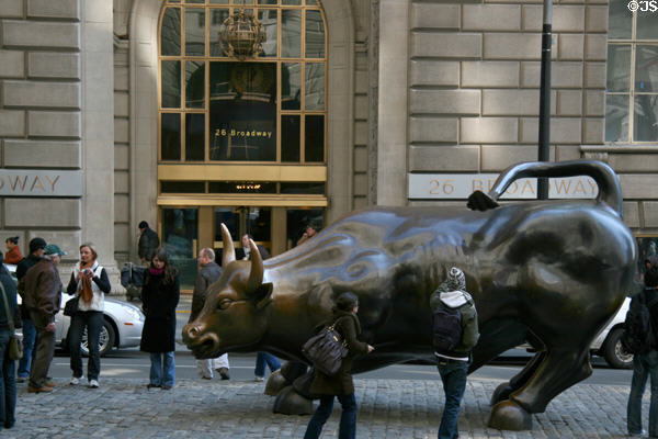 Charging Bull sculpture (1989) by Arthuro Di Modica on Bowling Green is photographed by most tourists. New York, NY.