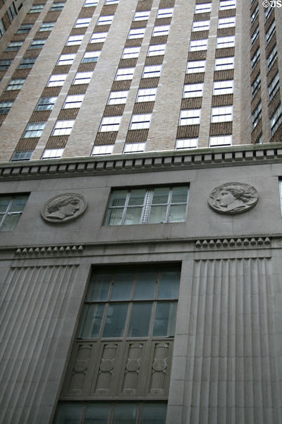 Coins & neoclassical ornaments on ground floors of The Crest highrise on Wall Street. New York, NY.