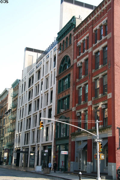 Streetscape along Bond St. from Lafayette with modern infill (25 Bond) among heritage buildings. New York, NY.
