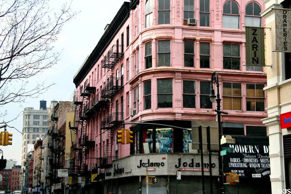 Pink rounded corner heritage building (Orchard at Grand St.). New York, NY.