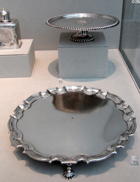 Silver salvers rear (1700-15) by John Coney of Boston & front (1735-45) by Simeon Soumaine of New York City at Metropolitan Museum of Art. New York, NY.