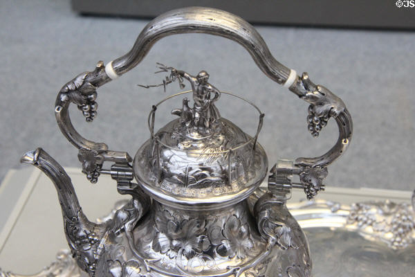 Detail of silver tea kettle with Zeus holding lightning bolt symbolic of electricity for telegraph company to which it was presented (1850) by John C. Moore of New York City at Metropolitan Museum of Art. New York, NY.