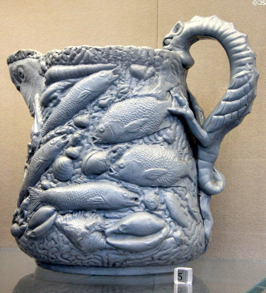 Earthenware pitcher sculpted as fish & sea creatures (1850-7) by Charles Coxon for E. & W. Bennett Pottery of Baltimore, MD at Metropolitan Museum of Art. New York, NY.