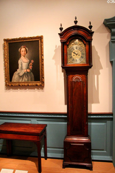 Tall clock (1789) beside card table (c1786) both from Newport, RI by John Townsend at Metropolitan Museum of Art. New York, NY.