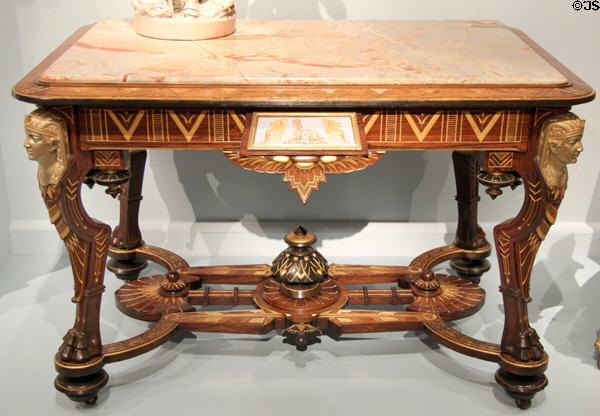Egyptian revival center table (1870-5) attrib. Pottier & Stymus Manufacturing Co. of New York City at Metropolitan Museum of Art. New York, NY.