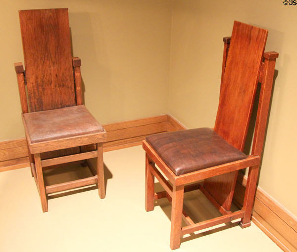 Frank Lloyd Wright slant-back side chair (1904-6) for Larkin Building of Buffalo, NY & earlier version with higher support (c1899-1904) for perhaps his own Oak Park home at Metropolitan Museum of Art. New York, NY.