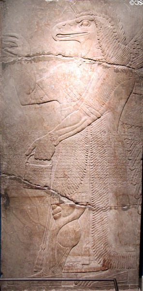 Assyrian relief of eagle-headed genie (apkallu) (883-859 BCE) from King Ashur-nasir-pal II palace of Nimrud at Brooklyn Museum. Brooklyn, NY.