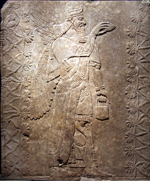 Assyrian relief of winged genie with horned helmet (883-859 BCE) from King Ashur-nasir-pal II palace of Nimrud at Brooklyn Museum. Brooklyn, NY.