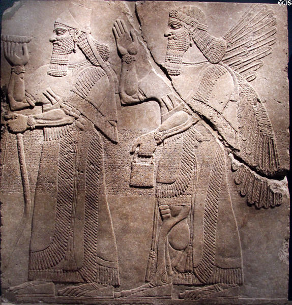 Assyrian relief of King Ashur-nasir-pal II & winged genie (883-859 BCE) from King Ashur-nasir-pal II palace of Nimrud at Brooklyn Museum. Brooklyn, NY.