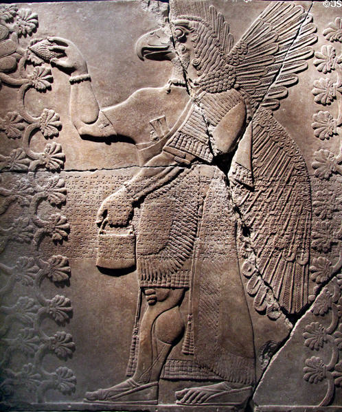 Assyrian relief of eagle-headed genie with between two sacred trees (883-859 BCE) from King Ashur-nasir-pal II palace of Nimrud at Brooklyn Museum. Brooklyn, NY.