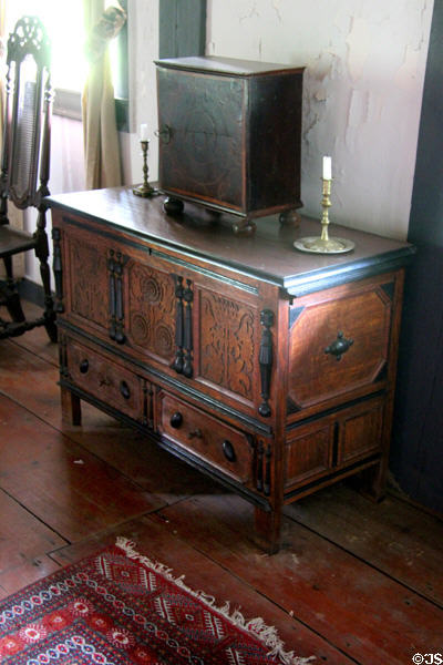 Chest with one drawer & carved sunflower (late 17th - early 18thC) in Connecticut style supporting bible box in Schenck House parlor at Old Bethpage Village. Old Bethpage, NY.