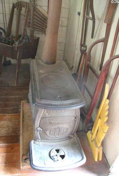 Antique cast iron Pine Knot wood stove (c1868) by J.L. Mott Iron Works of New York in Layton General Store at Old Bethpage Village. Old Bethpage, NY.