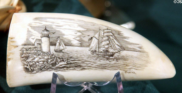 Scrimshaw lighthouse & ship scene on tooth at Whaling Museum. Cold Spring Harbor, NY.