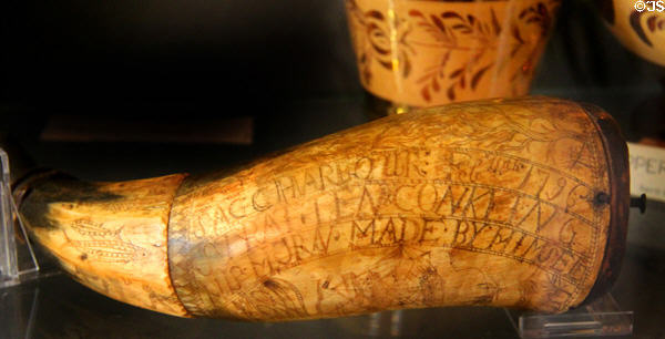 Engraved whale tooth powder horn (1796) carved by Stratton Conkling at Sag Harbor Whaling Museum. Sag Harbor, NY.