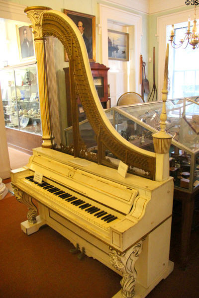 Kuhn "Giraffe" piano (1860-80) by Kuhn Piano Co. (Baltimore, MD) earliest upright or vertical piano in America at Sag Harbor Whaling Museum. Sag Harbor, NY.