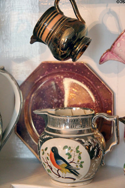 Lusterware pitcher with white floral design on silver & multicolor bird medallion at Home Sweet Home Museum. East Hampton, NY.