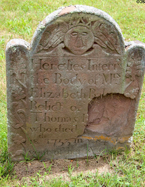Old tombstone with winged face (1753) in South End Burying Grounds. East Hampton, NY.