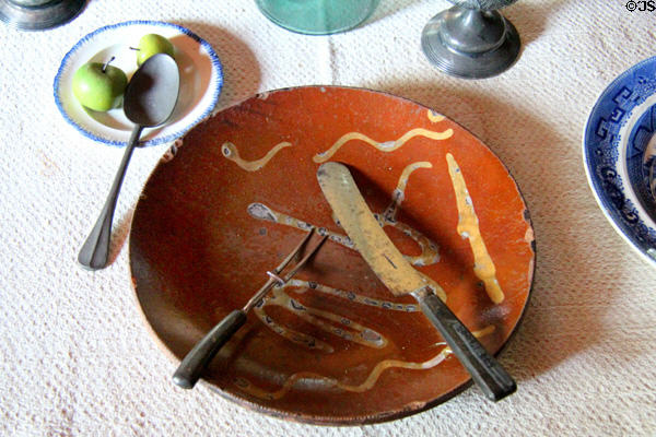 Table setting with knife & fork on redware plate at Thomas Halsey Homestead. South Hampton, NY.