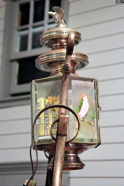 Detail of decorated lamp on fire hose cart (1870) at carriage collection of Long Island Museum. Stony Brook, NY.