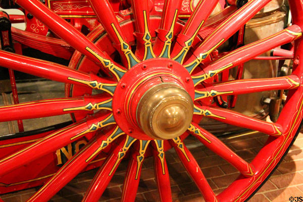 Detail of wooden carriage wheel of steam pumper (1874) by Amoskeac Manu. Co. of Manchester, NH at carriage collection of Long Island Museum. Stony Brook, NY.