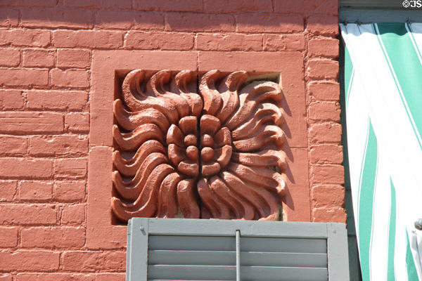 Ceramic brick sculpted flower on facade at Sagamore Hill National Historic Site. Cove Neck, NY.