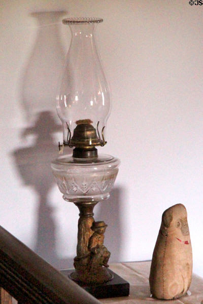 Oil lamp with figure on base at Roosevelt's House Sagamore Hill NHS. Cove Neck, NY.