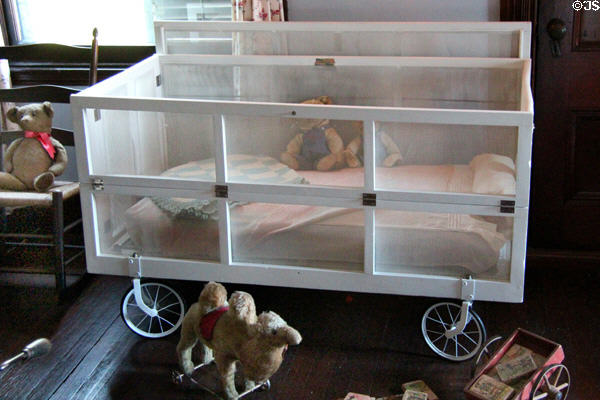 Wheeled screened bed with toys in Nursery at Roosevelt's House Sagamore Hill NHS. Cove Neck, NY.