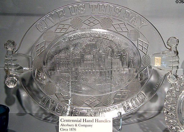Give us this Day pressed glass plate with hand handles (1876) by Alterbury & Co., for Centennial Exhibition at Milan Historical Museum. Milan, OH.