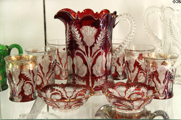 Thistle line glass pitcher & tumblers in red at National Museum of Cambridge Glass. Cambridge, OH.