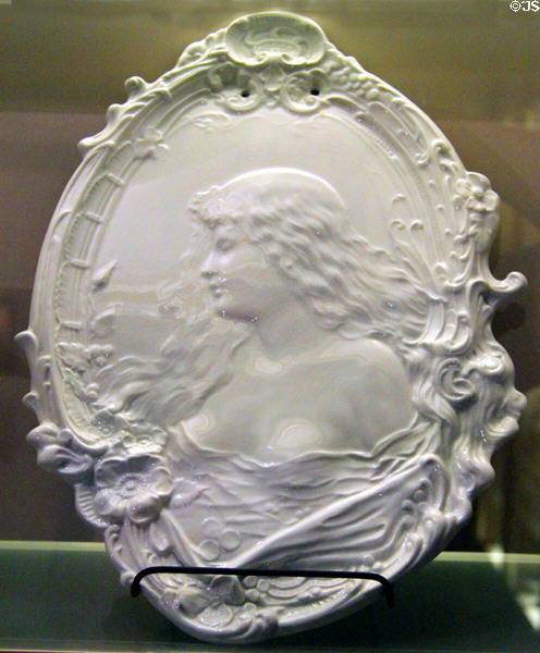 Whiteware plaque with bas relief woman (c1897) by Homer Laughlin at Museum of Ceramics. East Liverpool, OH.