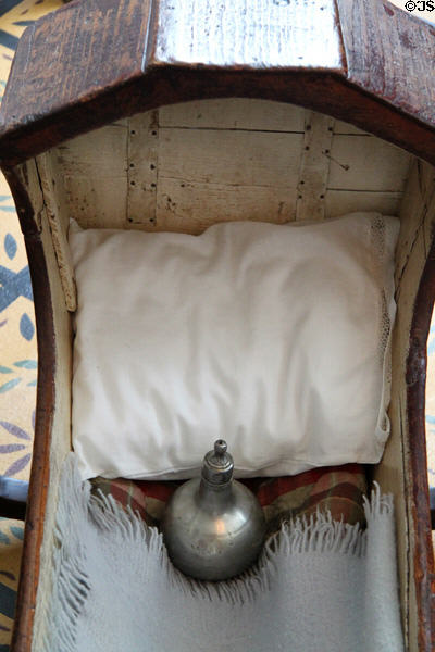 Cradle with antique baby bottle in Whitney home at Historic Kirtland Village. Kirtland, OH.