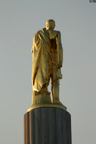 Rear of The Pioneer gilded statue atop Oregon State Capitol. Salem, OR.