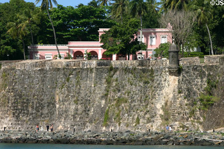 San Juan city walls dwarf Casa Rosa (1812). San Juan, PR.
