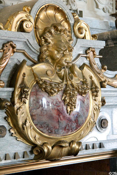 Late Renaissance style fireplace shield with lion holding garland in Morning Room at The Breakers. Newport, RI.