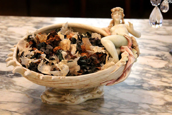 Ceramic bowl with reclining female figure on rim at Rosecliff. Newport, RI.