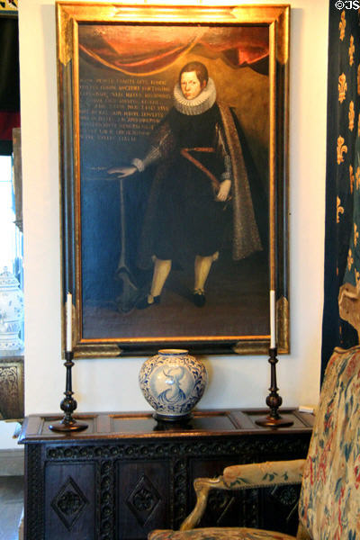 Boy standing beside table Italian painting (c1556) over antique chest at Rough Point. Newport, RI.