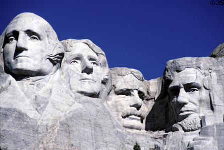 The carved faces of George Washington, Thomas Jefferson, Theodore Roosevelt and Abraham Lincoln on Mount Rushmore. SD.