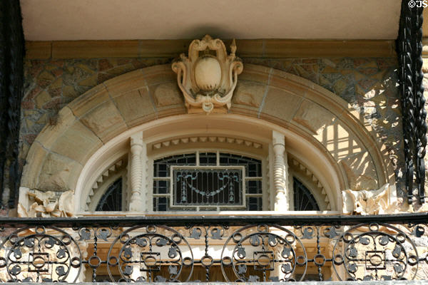 Bishop's Palace window arch with carvings & iron railings. Galveston, TX.
