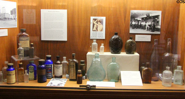 Collection of antique medicine bottles in lobby at Houston City Hall. Houston, TX.