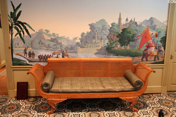 Caned settee under French reproduction mural wallpaper with Indian scene in Music Room at Bayou Bend. Houston, TX.