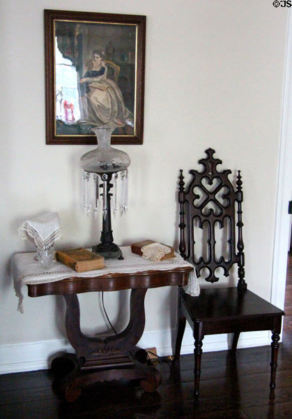 Oil lamp on lyre table beside Gothic side chair at Nichols-Rice-Cherry House at Sam Houston Park. Houston, TX.