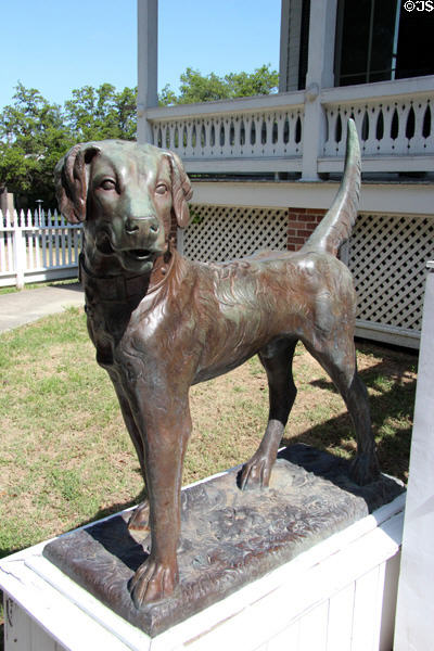 Cast dog statue before Pilot House at Sam Houston Park. Houston, TX.