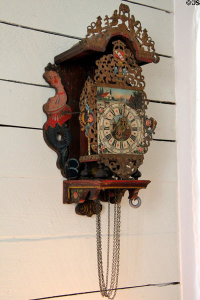 Carved German wall clock in San Felipe Cottage at Sam Houston Park. Houston, TX.