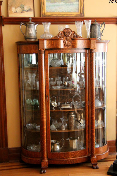 Vitrine with collection of glass & silver in Staiti House at Sam Houston Park. Houston, TX.
