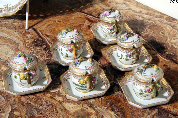 Porcelain Royal Copenhagen 'Flora Danica' custard cups on octagonal saucers 20th C at Rienzi house museum. Houston, TX.