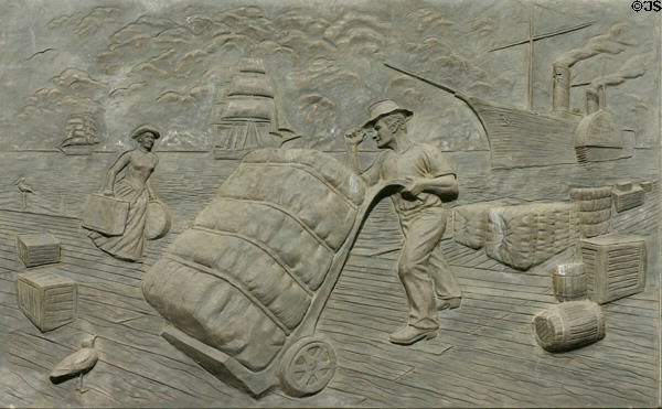 Sculpted history panel of loading cotton onto paddlewheel steamer by Michael O'Brien on Texas State History Museum. Austin, TX.