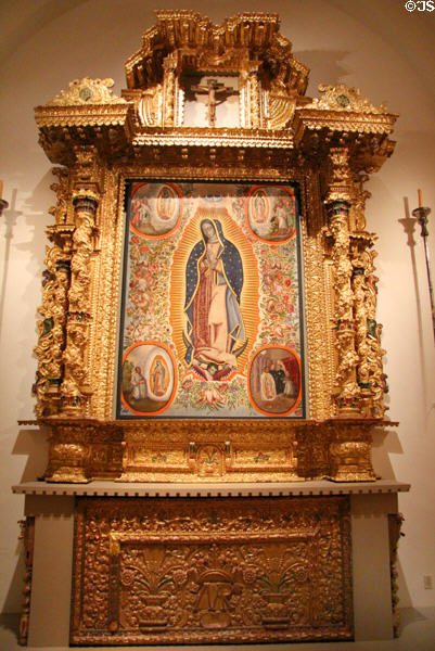 Virgin of Guadalupe from Mexico on altar screen from Bolivia (both 18th C) at San Antonio Museum of Art. San Antonio, TX.