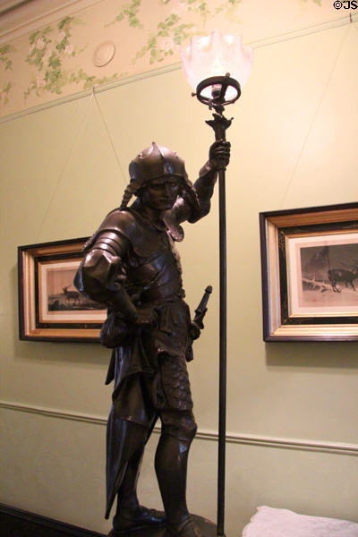 Bronze guilt warrior lamp brought back by the Steves from visit to Centennial Exhibition in Philadelphia (1876) on newel post in central hall at Edward Steves Homestead Museum. San Antonio, TX.