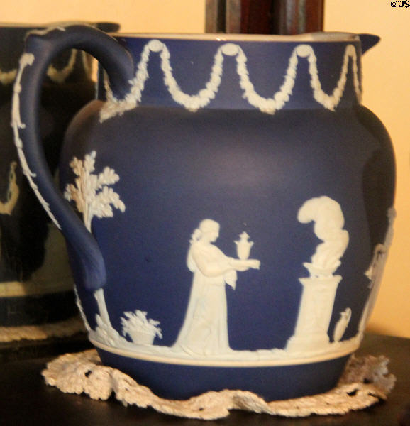 White on blue bisque pitcher show woman with urn at Edward Steves Homestead Museum. San Antonio, TX.