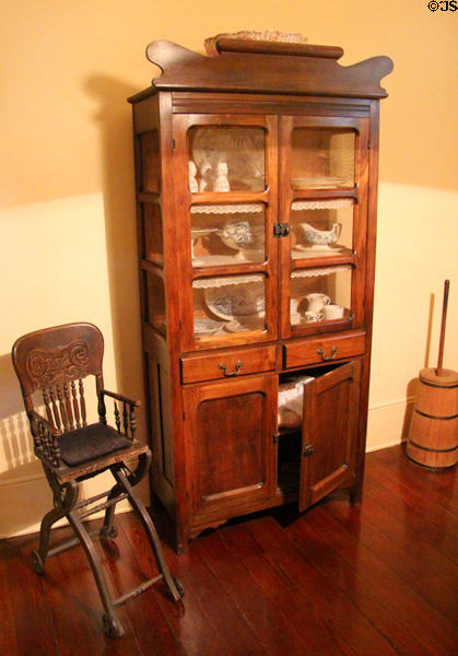 Kitchen china cabinet & rolling high chair at Edward Steves Homestead Museum. San Antonio, TX.